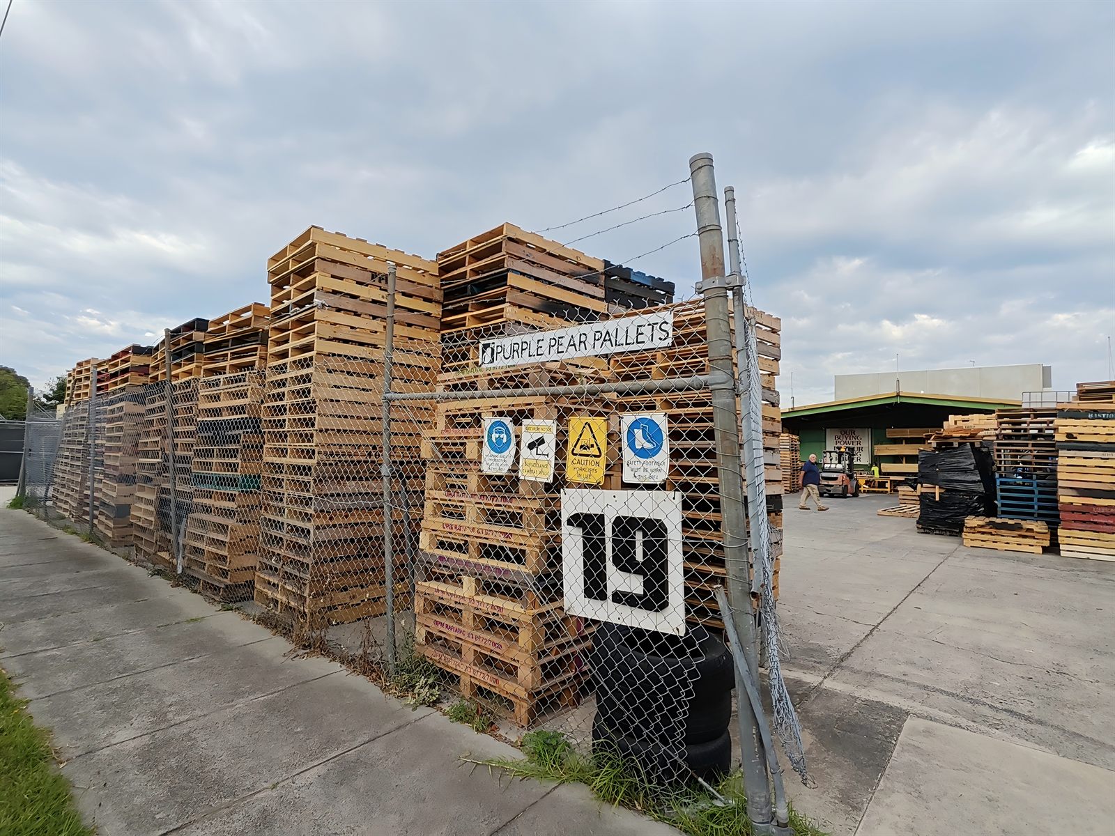 Stacks of repaired timber pallets at Purple Pear Pallets